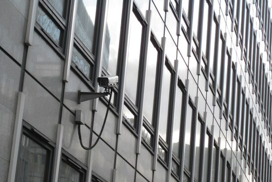A CCTV camera mounted on the exterior of a building in London.