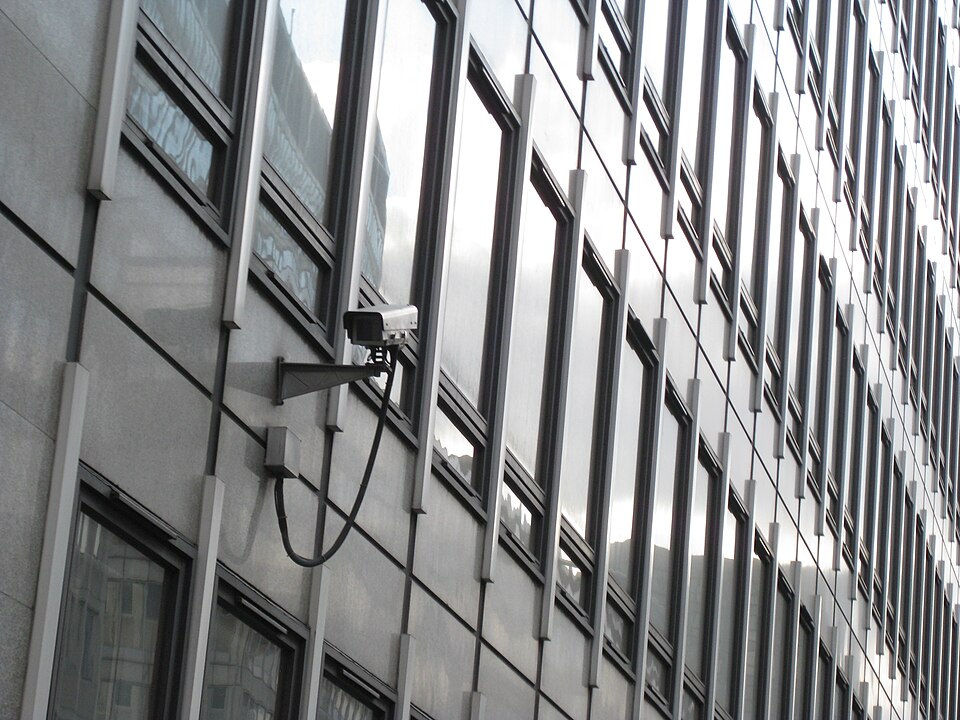 A CCTV camera mounted on the exterior of a building in London.