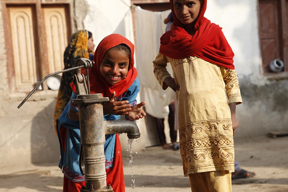 Children beside a village water pump in Sindh, Pakistan.